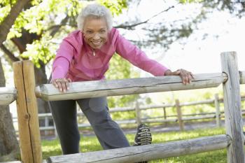 Senior African American Woman Exercising In Park