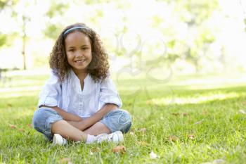 African American Girl Sitting In Park