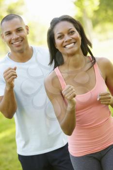 Young African American Couple Jogging In Park