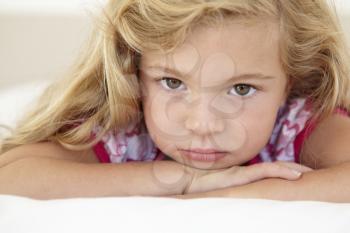 Young Girl Looking Sad On Bed In Bedroom
