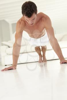 Young Bare Chested Man Exercising At Home