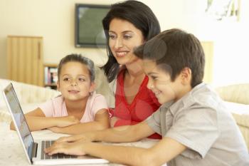 Hispanic Mother And Children Using Computer At Home