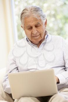 Senior Hispanic man with laptop