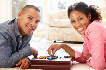 Mixed race couple playing solitaire