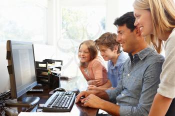 Family with computer in home office