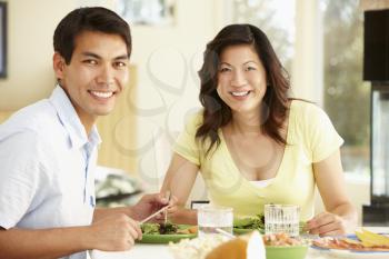 Asian couple sharing meal at home
