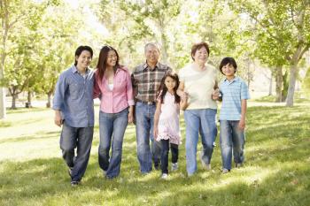 Multi-generation Asian family walking in park