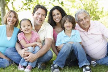 Multi Generation Hispanic Family Standing In Park