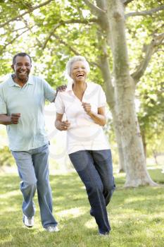 Senior African American Couple Running In Park