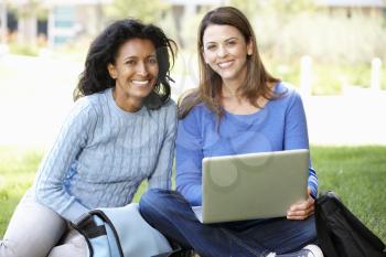 Women using laptop outdoors