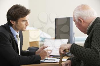 Doctor talking to senior male patient