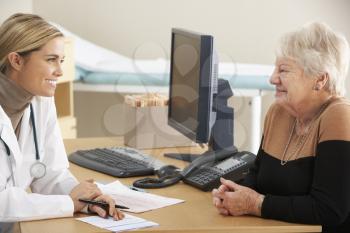 Doctor talking to senior woman patient