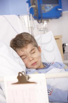 Young boy asleep in hospital bed