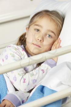 Young girl lying in hospital bed