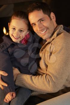 Portrait father and daughter by firelight