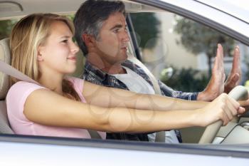 Nervous Father Teaching Teenage Daughter To Drive