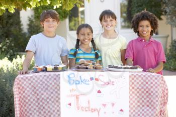 Group Of Children Holding Bake Sale