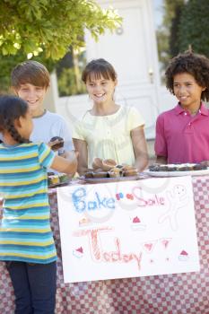 Group Of Children Holding Bake Sale