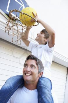 Father And Son Family Playing Basketball Outside Garage