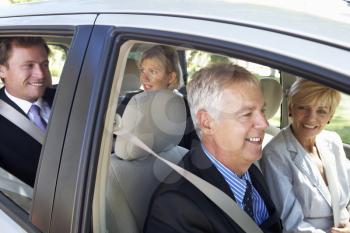 Group Of Business Colleagues Car Pooling Journey Into Work