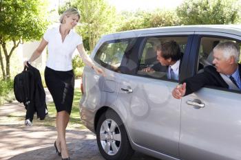 Businesswoman Running Late To Meet Colleagues Car Pooling Journey Into Work