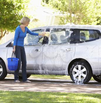 Woman Washing Car In Drive