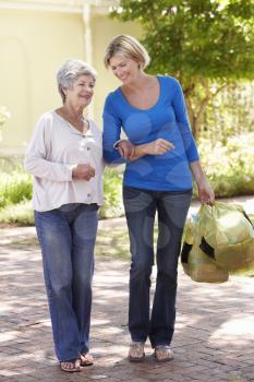 Woman Helping Senior Female With Shopping