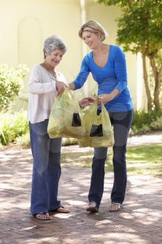 Woman Helping Senior Female With Shopping