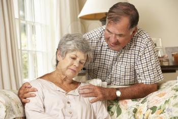 Senior Man Comforting Unhappy Wife At Home