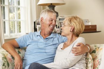 Mature Couple Sitting On Sofa At Home Together