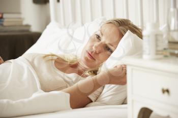 Medication On Bedside Table Of Sleepless Woman