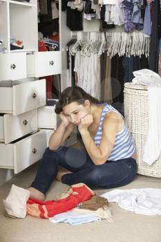 Unhappy Teenage Girl Unable To Find Suitable Outfit In Wardrobe