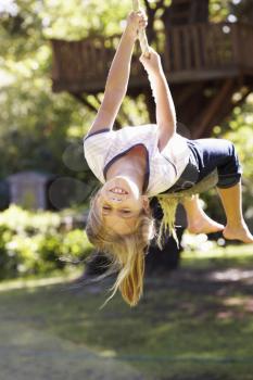 Young Girl Having Fun On Rope Swing