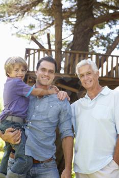 Grandfather, Father And Son Standing By Tree House Together