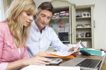 Couple Looking At Finances In Home Office Together