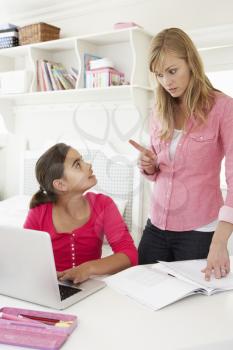Unhappy Mother Telling Off Daughter For Not Doing Homework
