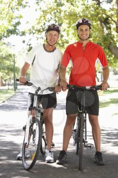 Two Men Cycling Through Park