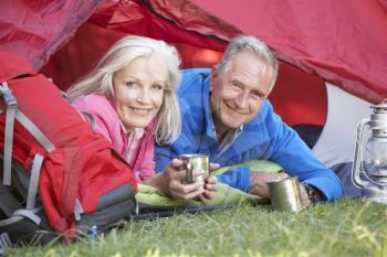 Senior Couple Inside Tent On Camping Holiday