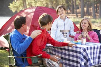 Family Enjoying Meal On Camping Holiday