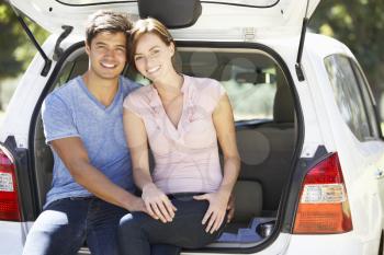 Couple Sitting In Trunk Of Car