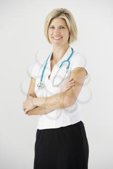 Studio Portrait Of Female Doctor Against White Background