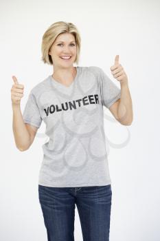 Portrait Of Female Volunteer Giving Thumbs Up