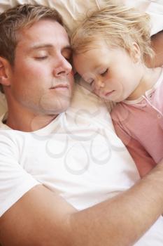 Father And Daughter Sleeping In Bed