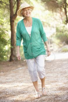 Senior Woman Walking In Countryside