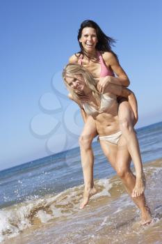 Two Female Friends Having Fun On Beach Holiday Together
