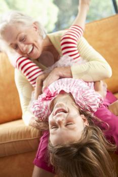 Grandmother And Granddaughter Having Fun On Sofa
