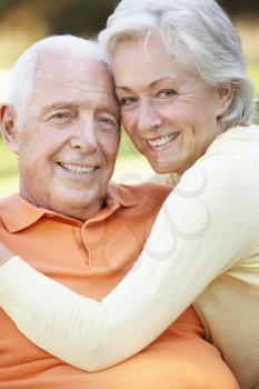 Head And Shoulders Portrait Of Romantic Senior Couple In Park