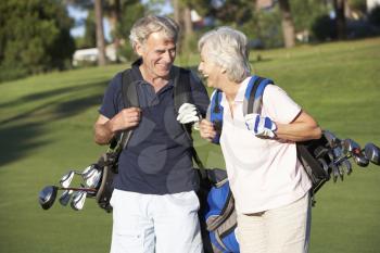 Senior Couple Enjoying Game Of Golf