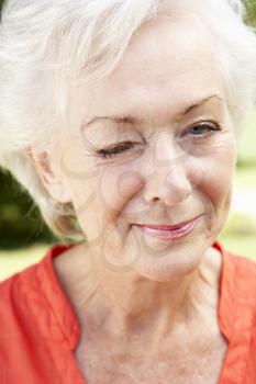 Head And Shoulders Portrait Of Winking Senior Woman