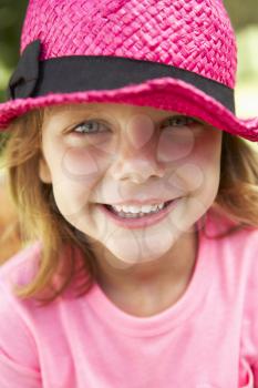 Head And Shoulders Portrait Of Girl Wearing Pink Straw Hat